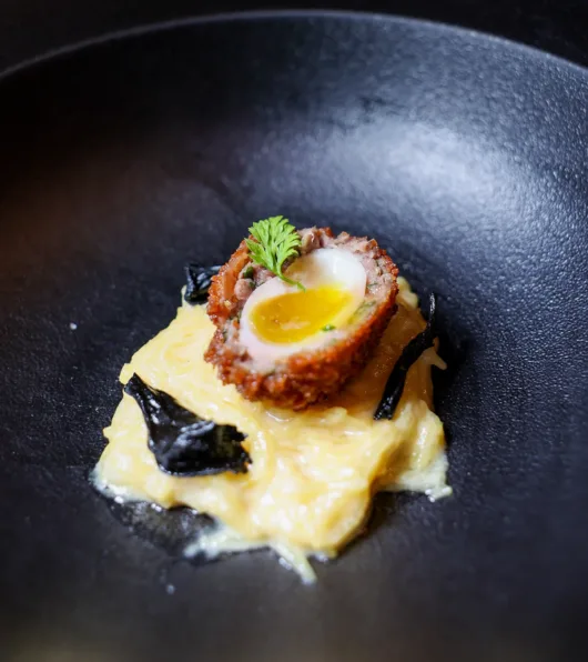 Scotch-style quail egg wrapped in venison sausage over spaghetti squash at Restaurant Latour.