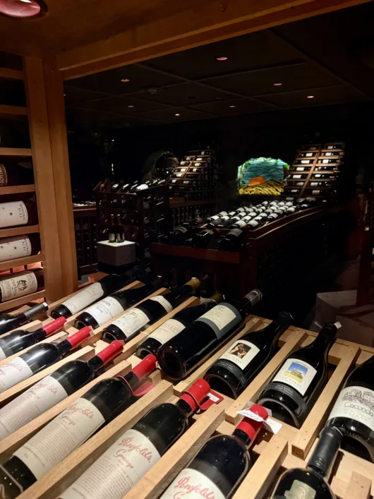 Rows of red wine bottles stored in racks at the Crystal Springs Resort wine cellar.