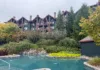 Outdoor pool at Crystal Springs Resort with Grand Cascades Lodge in the background.