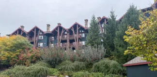 Outdoor pool at Crystal Springs Resort with Grand Cascades Lodge in the background.