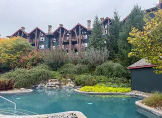 Outdoor pool at Crystal Springs Resort with Grand Cascades Lodge in the background.