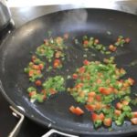 Sweating bell peppers and scallions for stuffed crab meat mushrooms