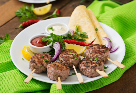 Appetizing kofta kebab (meatballs) with sauce and tortillas tacos