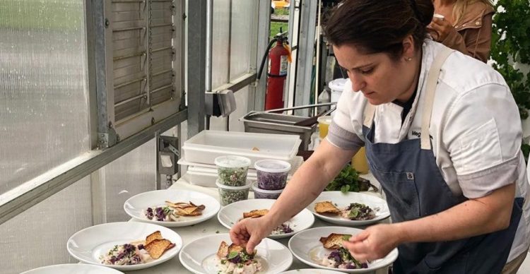 photo of Chef Meg LaManna plating dishing for a party