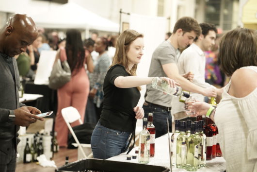 woman pouring wine at festival
