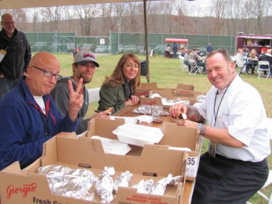 people around a table with food