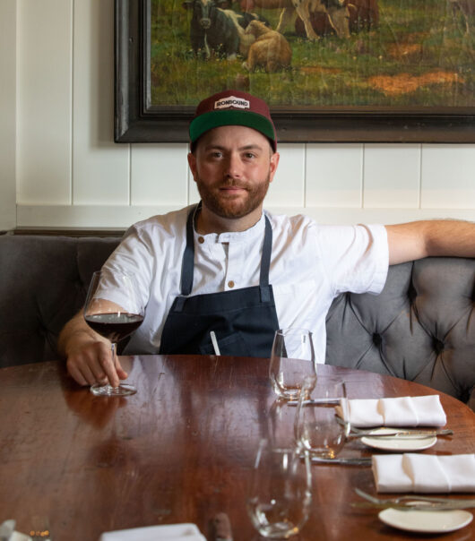 Chef AJ seated at table