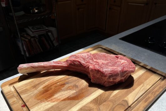 tomahawk steak on cutting board