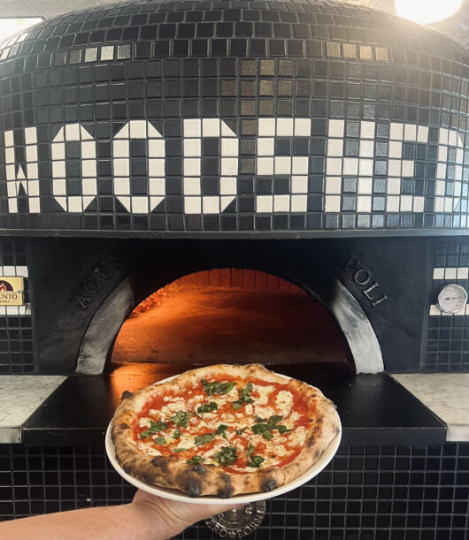 woodshed pizza in front of pizza oven