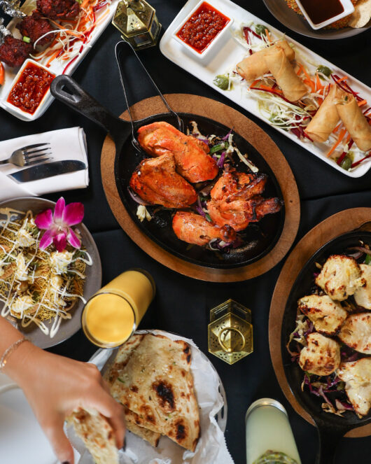 a table full of food at new NJ restaurant, Sea & Sand Indian Fusion