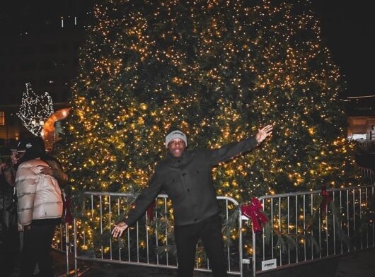 posing in front of the Christmas Tree at Newark Winter Village