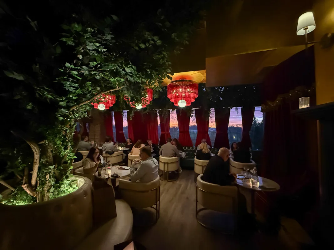 Lounge seating at Olea Restaurant in Spring Lake NJ with velvet drapes and maroon fringe chandeliers