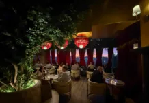 Lounge seating at Olea Restaurant in Spring Lake NJ with velvet drapes and maroon fringe chandeliers