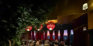 Lounge seating at Olea Restaurant in Spring Lake NJ with velvet drapes and maroon fringe chandeliers