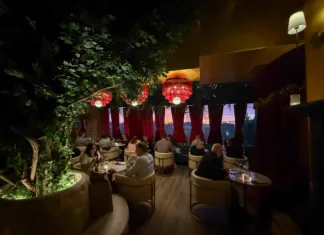 Lounge seating at Olea Restaurant in Spring Lake NJ with velvet drapes and maroon fringe chandeliers