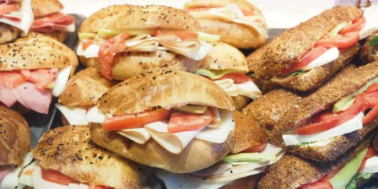 assortment of deli sandwiches including Italian subs, turkey sandwiches, and classic hoagies
