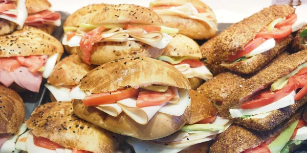 assortment of deli sandwiches including Italian subs, turkey sandwiches, and classic hoagies