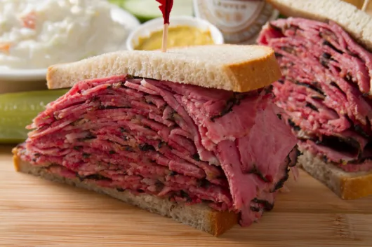 pastrami sandwich from Hobby's Deli stacked with hand-carved pastrami on rye bread