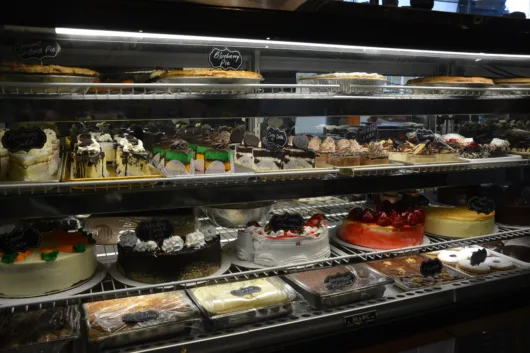 Dessert display case filled with cakes and pastries at Ridge Diner in Park Ridge New Jersey