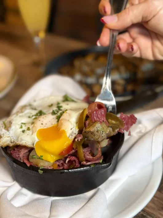 A colorful brunch spread at B2 Bistro + Bar in Red Bank featuring eggs, French toast, breakfast cocktails, and brunch favorites.