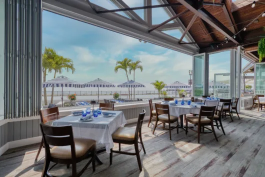 Outdoor waterfront dining at Rooney's Oceanfront Restaurant in Long Branch, NJ, overlooking the Atlantic Ocean.