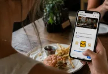 A restaurant guest uses the twocents app on her smartphone to share private feedback about her dining experience.
