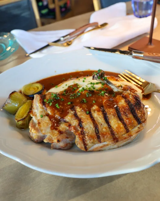 Chicken Au Poivre at Marée Kitchen + Bar in Spring Lake, NJ served with creamy aligot potatoes and a peppercorn jus.