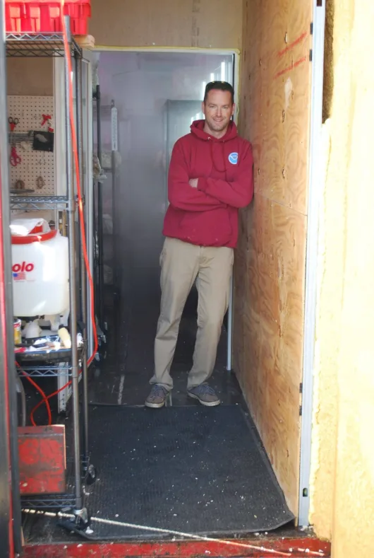 KC Sullivan inside the original Two River Gourmet Mushrooms shipping container farm in Long Branch, New Jersey