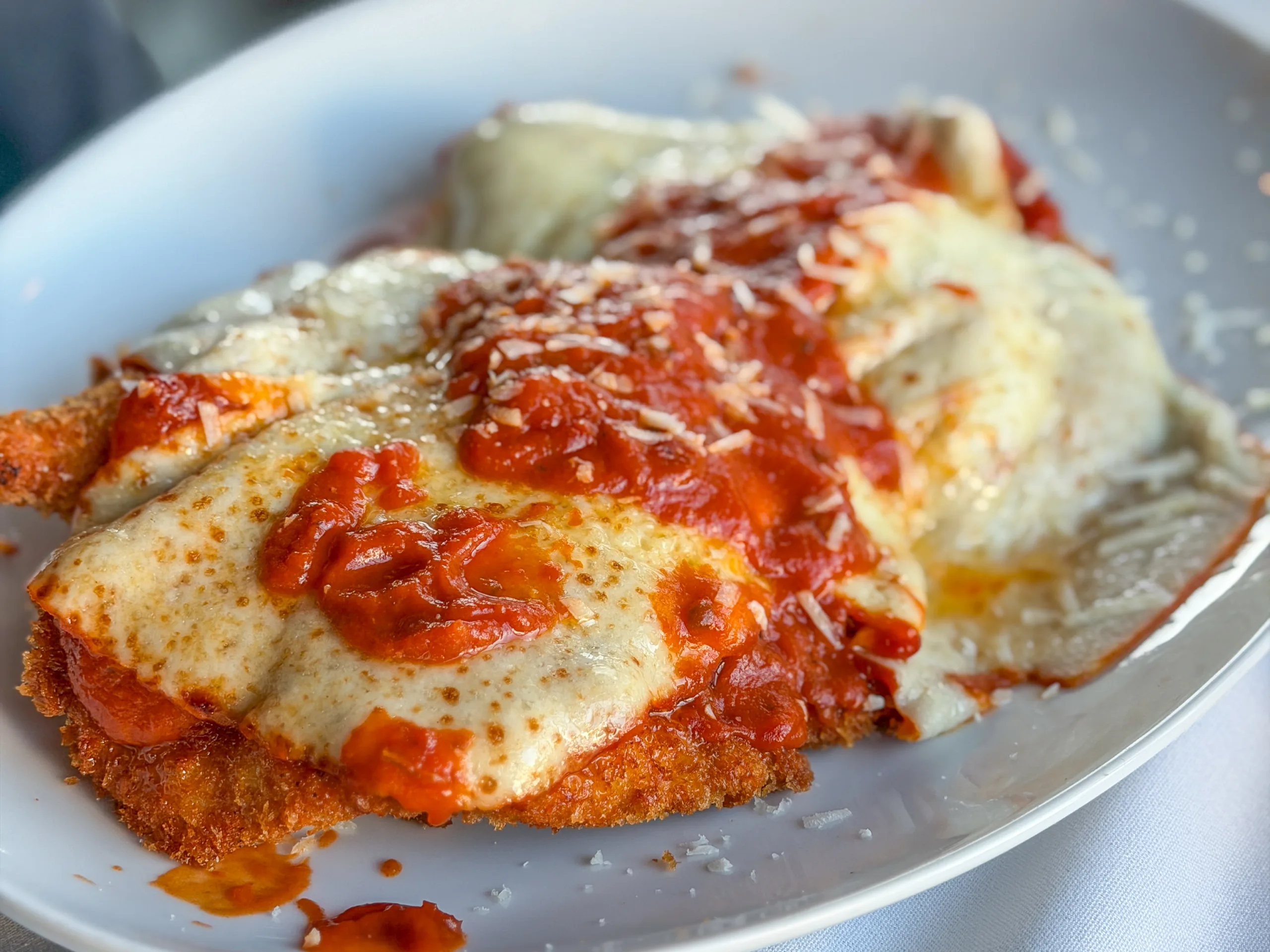 Chicken Parmesan topped with melted cheese and tomato sauce at Dune, a coastal Italian restaurant in Ortley Beach, New Jersey.