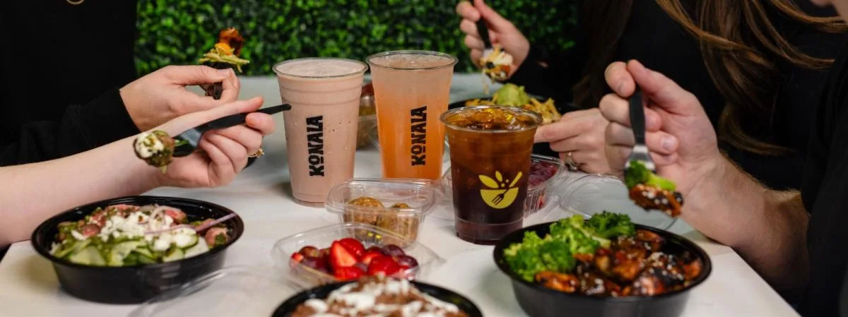 Guests enjoying high-protein bowls, salads, fresh fruit, and drinks at Konala in Belleville, New Jersey.