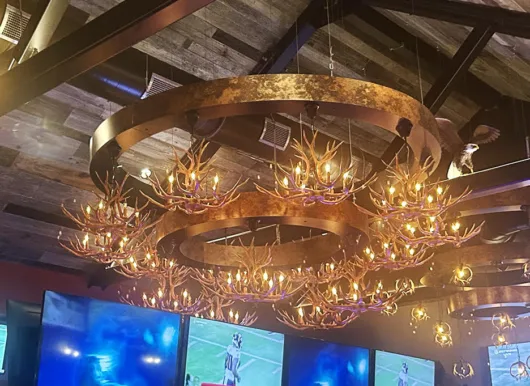 The lower level at Cuzin’s Seafood & Clam Bar in New Brunswick features a curved, ship-inspired design created by restaurant designer Raymond Haldeman.