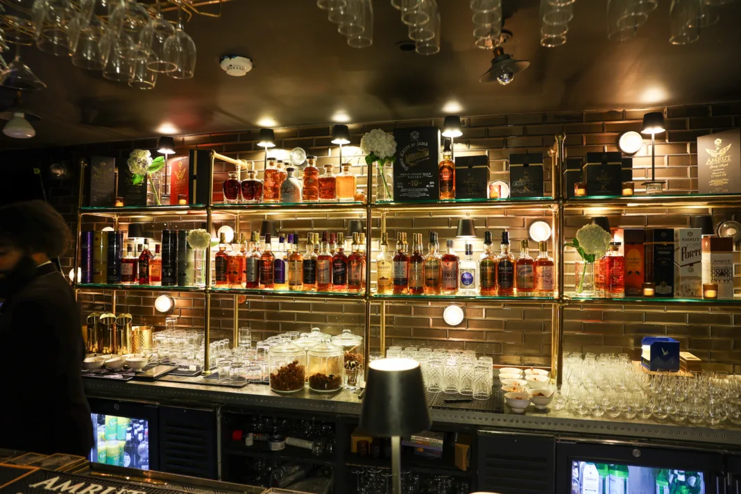 Back bar at House of Amrut in Jersey City displaying an extensive collection of Indian single malt whiskies.