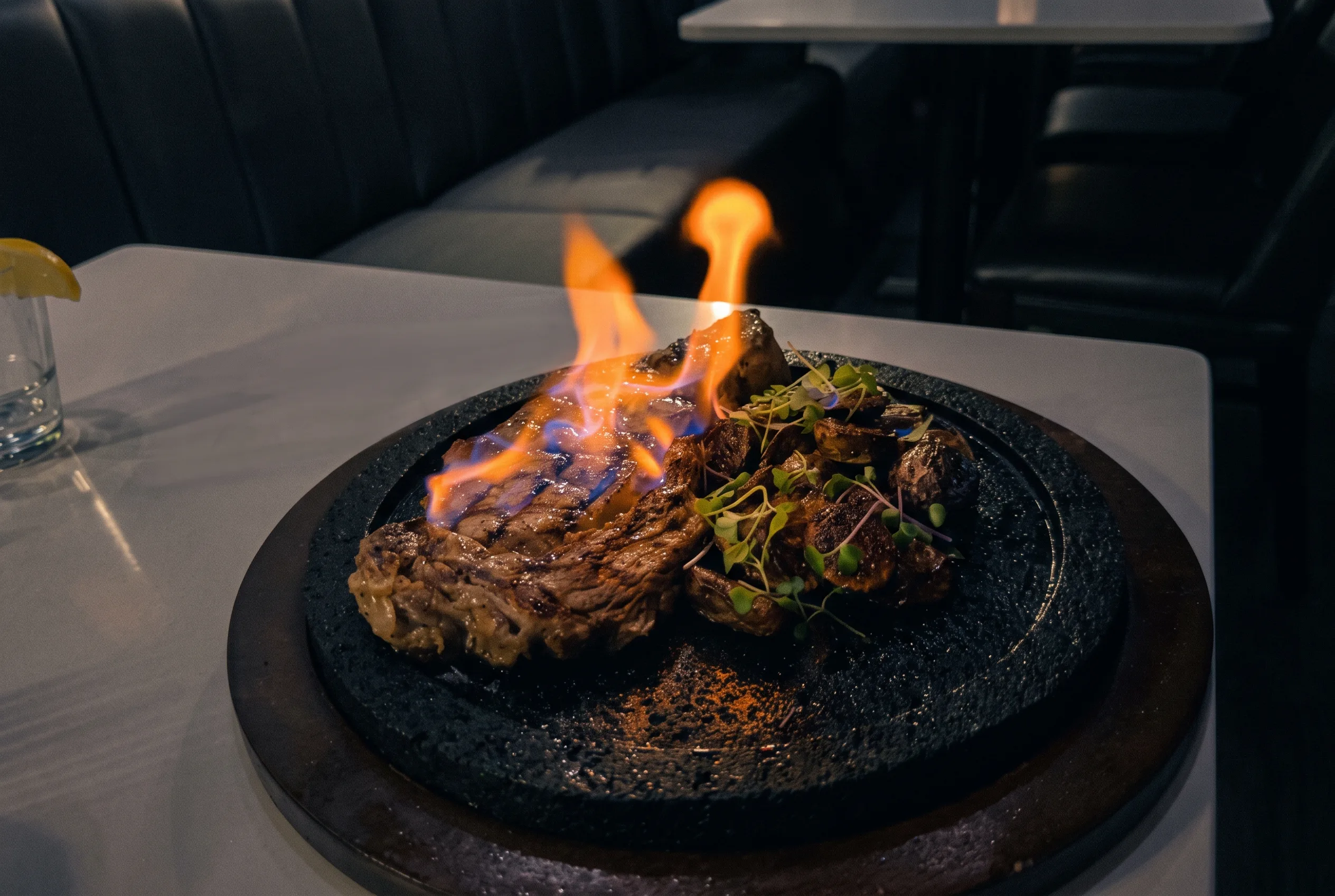 Flame-grilled veal chop served on a sizzling black stone plate at Azul Mexican restaurant in Hackensack, NJ.