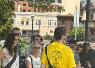 A group gathers for a guided Chow Town food tour on a sunny day in downtown New Jersey.