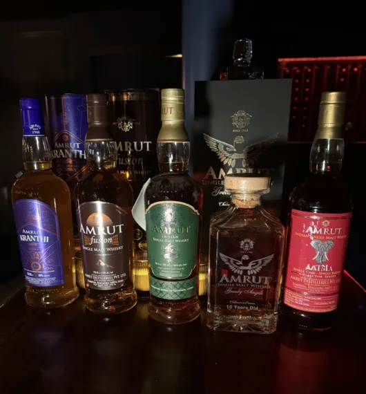 Selection of Amrut Indian single malt whisky bottles, including Kranthi, Fusion, Greedy Angels 10 Year Old, and Aatma.